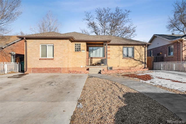 2042 Jamaica St, Aurora, CO 80010 - view of front of property featuring brick siding, fence, and roof with shingles