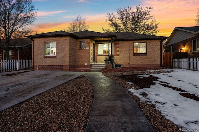 2042 Jamaica St, Aurora, CO 80010 - view of front of property with brick siding and fence