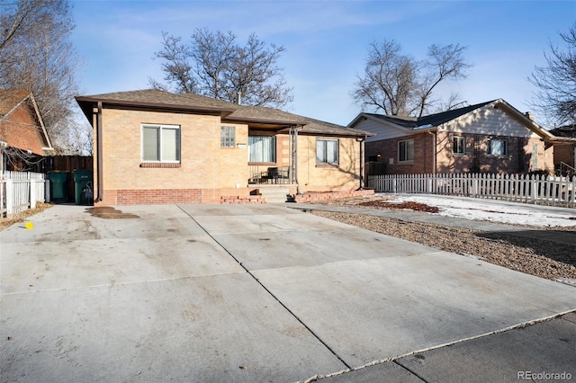 2042 Jamaica St, Aurora, CO 80010 - view of front of house with brick siding, fence, and a shingled roof