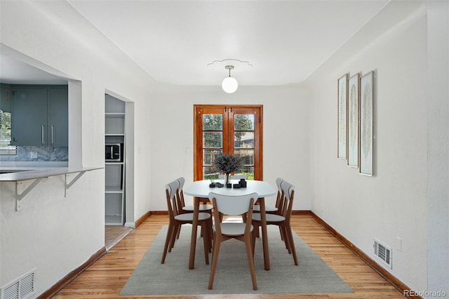 2042 Jamaica St, Aurora, CO 80010 - dining room with light wood-style flooring, healthy amount of natural light, and baseboards