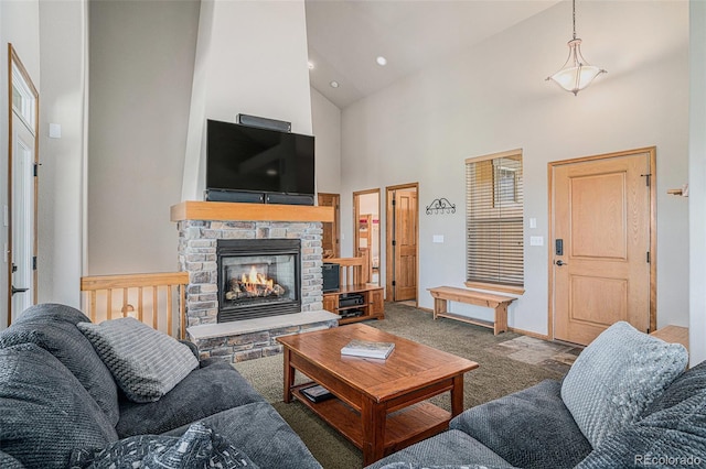 109 Peak Vw, Granby, CO 80446 - living room featuring high vaulted ceiling, carpet flooring, a stone fireplace, and baseboards