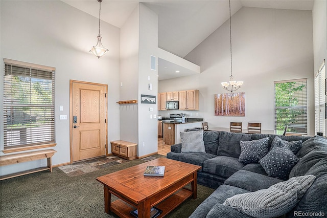 109 Peak Vw, Granby, CO 80446 - living room with high vaulted ceiling, a chandelier, baseboards, and dark stone finish floors