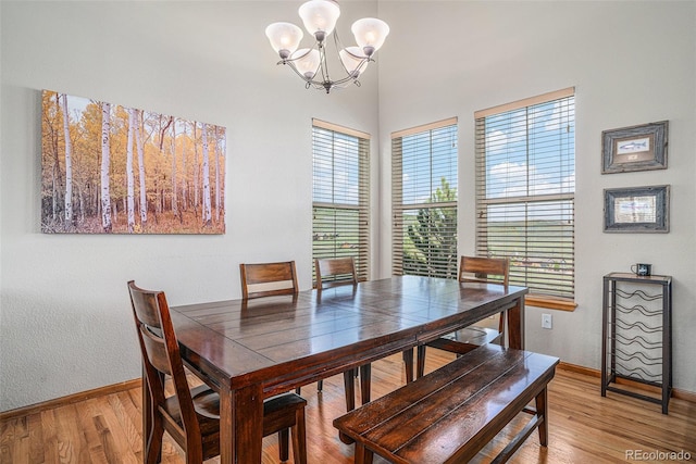 109 Peak Vw, Granby, CO 80446 - dining area with a chandelier, light wood-style flooring, baseboards, and healthy amount of natural light
