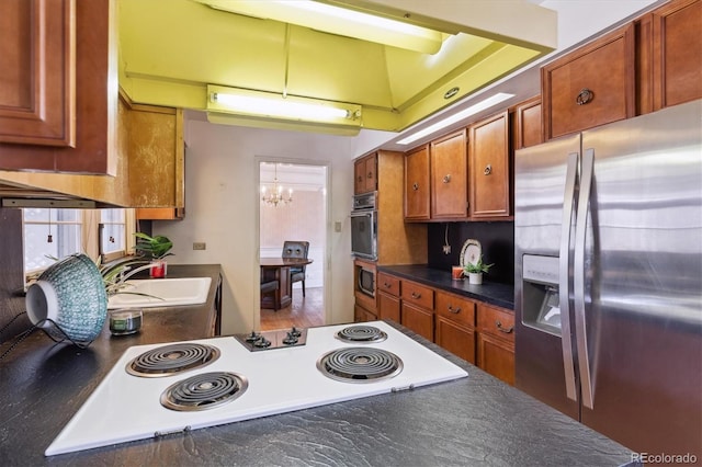 3201 S Albion St, Denver, CO 80222 - kitchen with stainless steel fridge with ice dispenser, oven, dark countertops, a sink, and a chandelier