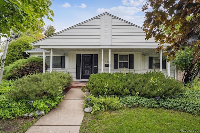 3201 S Albion St, Denver, CO 80222 - bungalow-style home featuring a porch and board and batten siding