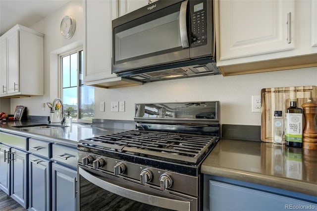 6880 Backcountry Loop, Colorado Springs, CO 80927 - kitchen featuring black microwave, stainless steel range with gas cooktop, a sink, and white cabinets