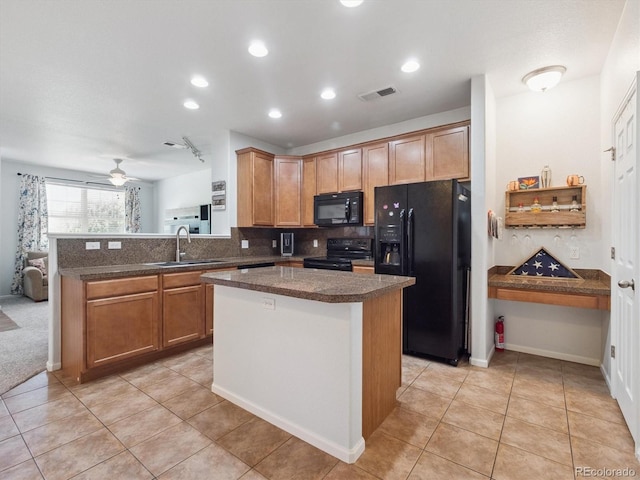 3662 S Perth Cir Unit 104, Aurora, CO 80013 - kitchen featuring black appliances, decorative backsplash, a peninsula, light tile patterned floors, and dark countertops