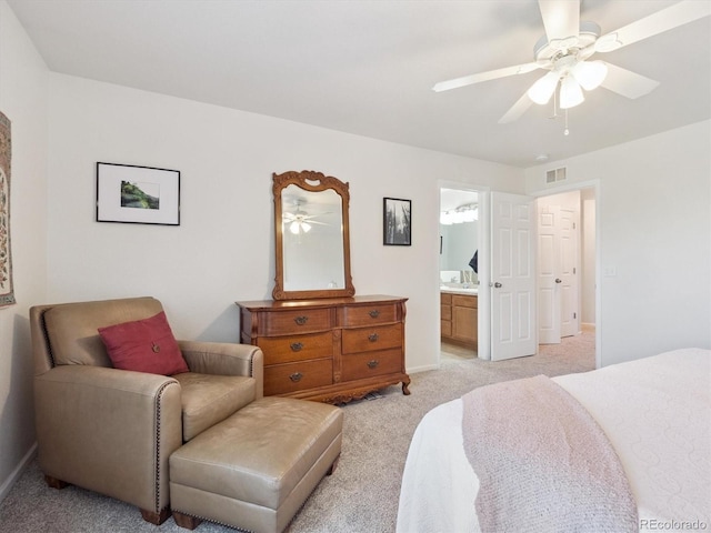 3662 S Perth Cir Unit 104, Aurora, CO 80013 - bedroom featuring light colored carpet, ensuite bath, and ceiling fan