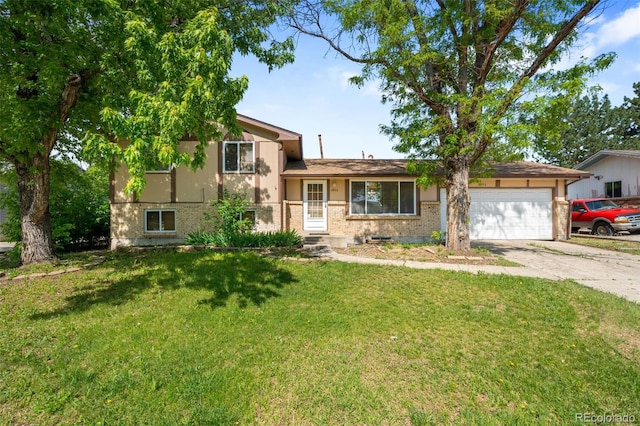 6953 Ingalls St, Arvada, CO 80003 - tri-level home featuring an attached garage, driveway, a front lawn, and brick siding