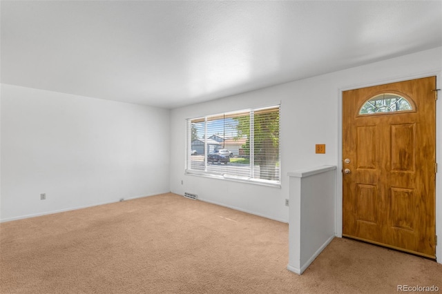 6953 Ingalls St, Arvada, CO 80003 - entryway featuring light carpet, healthy amount of natural light, and baseboards