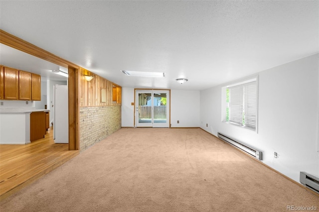 6953 Ingalls St, Arvada, CO 80003 - unfurnished living room featuring baseboard heating and light carpet