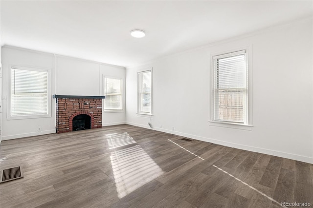 unfurnished living room with ornamental molding and a fireplace