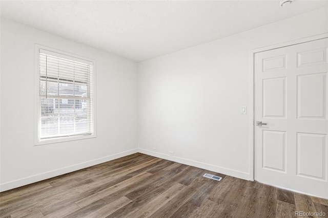 spare room with hardwood / wood-style flooring