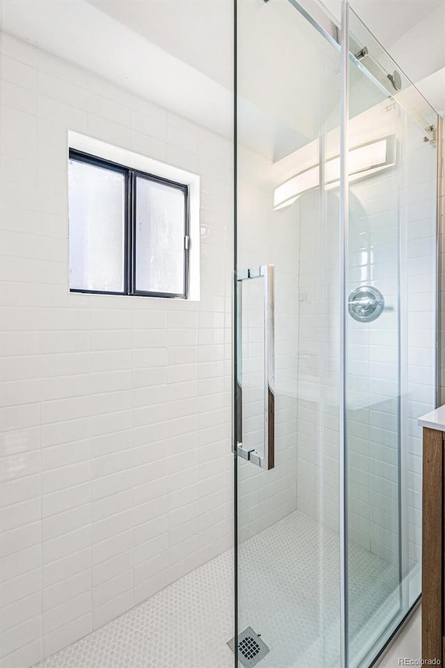 bathroom with a shower with door