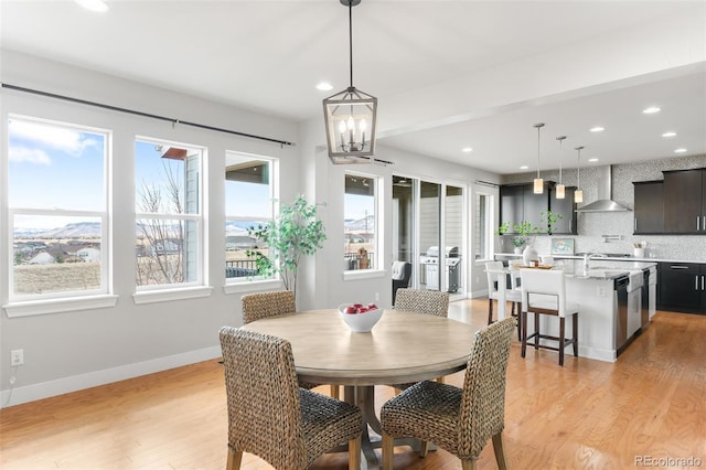 dining room featuring light wood-style floors, recessed lighting, and baseboards