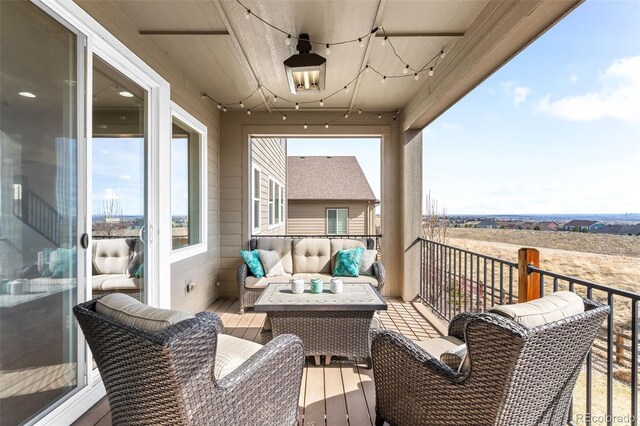 balcony featuring outdoor lounge area and a rural view