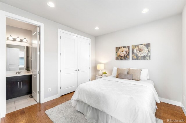 bedroom with light wood-style floors, baseboards, a closet, and recessed lighting