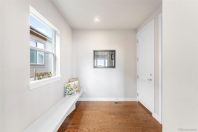 interior space featuring recessed lighting, wood finished floors, visible vents, and baseboards