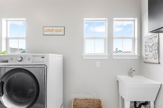 laundry area with washer / clothes dryer, a sink, and laundry area