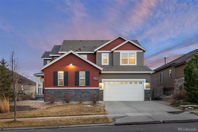 craftsman inspired home featuring driveway, stone siding, an attached garage, and roof with shingles