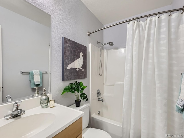 6065 Wadsworth Blvd Unit A, Arvada, CO 80003 - bathroom featuring shower / bath combo with shower curtain, toilet, vanity, and a textured wall