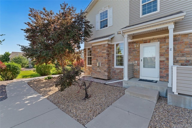 12784 Jasmine St Unit E, Thornton, CO 80602 - doorway to property with stone siding