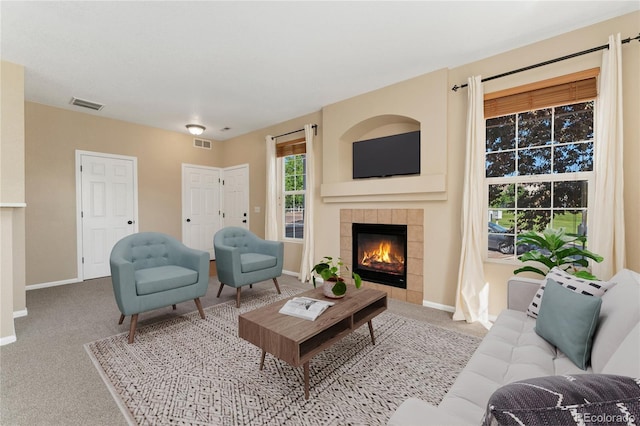 12784 Jasmine St Unit E, Thornton, CO 80602 - carpeted living area featuring a tiled fireplace and baseboards