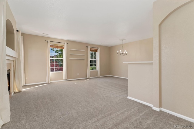 12784 Jasmine St Unit E, Thornton, CO 80602 - unfurnished living room featuring a chandelier, carpet floors, and a high end fireplace