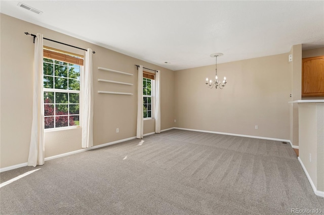 12784 Jasmine St Unit E, Thornton, CO 80602 - carpeted spare room featuring plenty of natural light and a chandelier