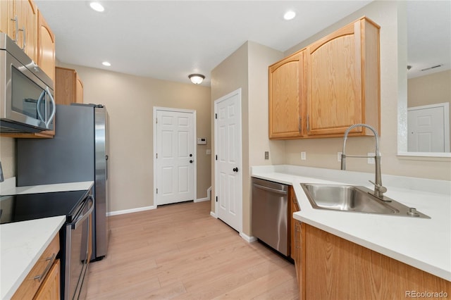 12784 Jasmine St Unit E, Thornton, CO 80602 - kitchen featuring stainless steel appliances, light wood-style floors, light countertops, recessed lighting, and light brown cabinets