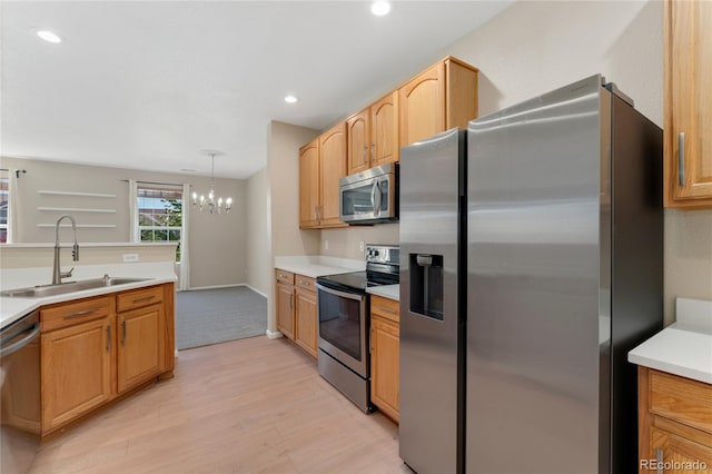 12784 Jasmine St Unit E, Thornton, CO 80602 - kitchen featuring appliances with stainless steel finishes, light wood finished floors, a chandelier, light countertops, and recessed lighting