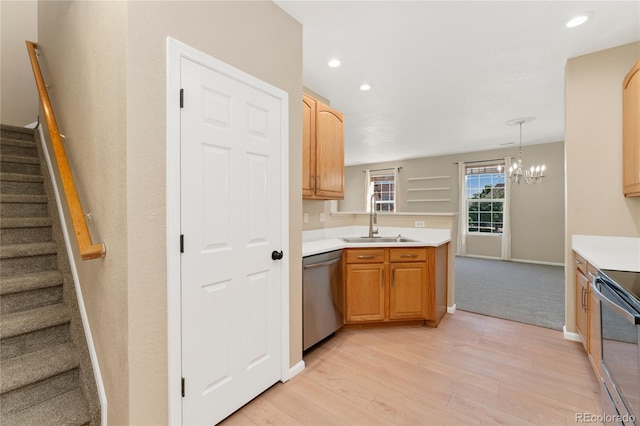 12784 Jasmine St Unit E, Thornton, CO 80602 - kitchen featuring appliances with stainless steel finishes, light wood-style floors, a chandelier, light countertops, and a peninsula