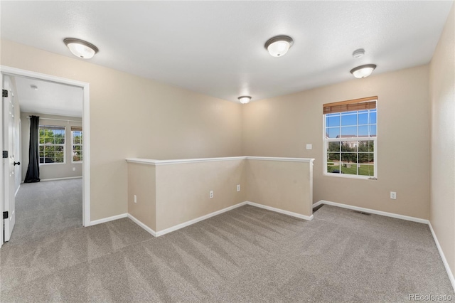 12784 Jasmine St Unit E, Thornton, CO 80602 - carpeted empty room featuring baseboards and a smoke detector