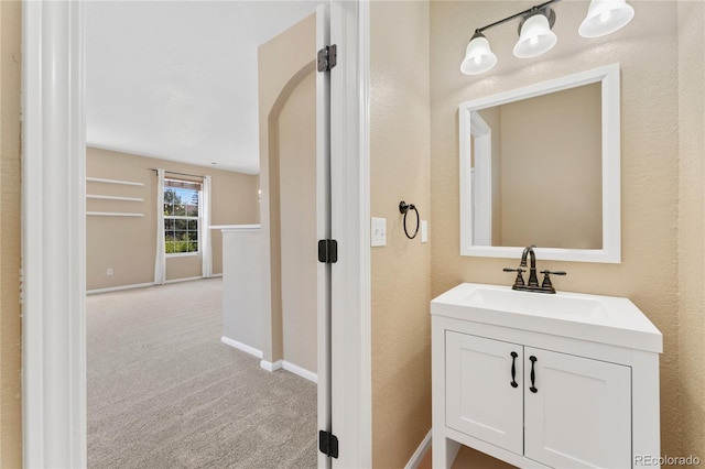 12784 Jasmine St Unit E, Thornton, CO 80602 - bathroom featuring vanity and baseboards