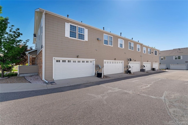 12784 Jasmine St Unit E, Thornton, CO 80602 - back of house featuring an attached garage