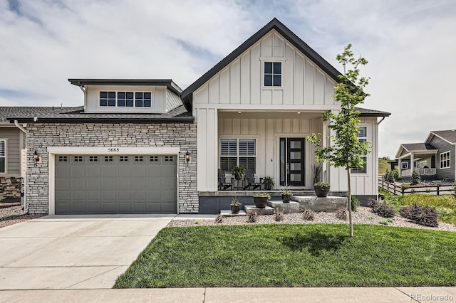 5668 Shadescale Way, Castle Rock, CO 80104 - view of front of home featuring board and batten siding, concrete driveway, covered porch, a front yard, and stone siding