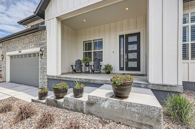 5668 Shadescale Way, Castle Rock, CO 80104 - property entrance featuring covered porch, concrete driveway, a garage, and board and batten siding