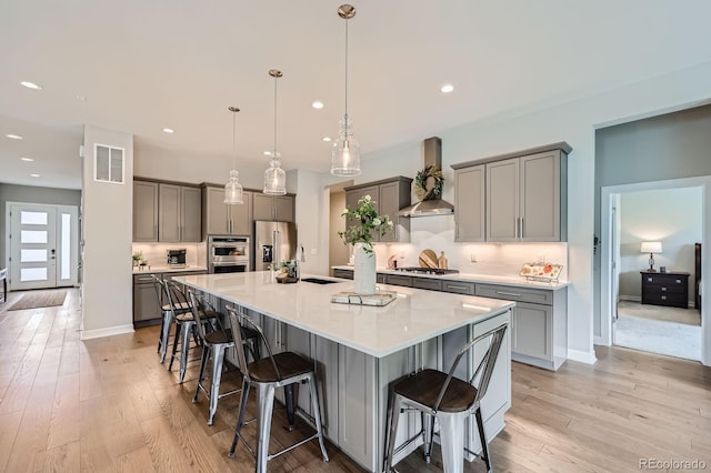 5668 Shadescale Way, Castle Rock, CO 80104 - kitchen with gray cabinets, stainless steel appliances, wall chimney exhaust hood, and recessed lighting