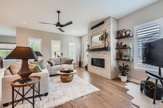 5668 Shadescale Way, Castle Rock, CO 80104 - living room featuring a ceiling fan, plenty of natural light, a fireplace, wood finished floors, and recessed lighting