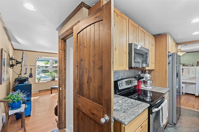 kitchen with light brown cabinetry, light wood-type flooring, tasteful backsplash, light stone counters, and stainless steel appliances