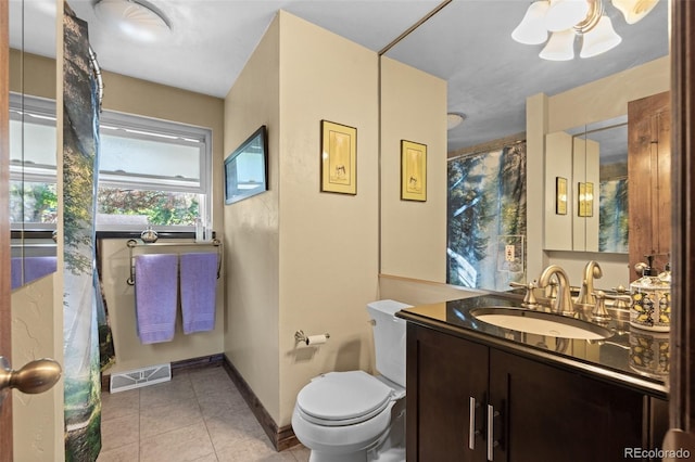 bathroom with tile patterned flooring, vanity, and toilet