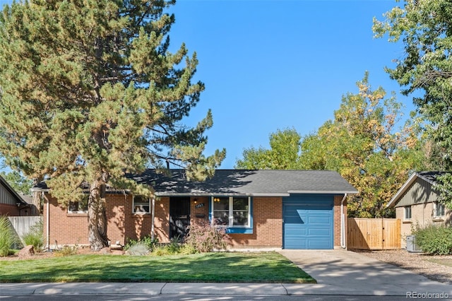 ranch-style home with a front lawn and a garage