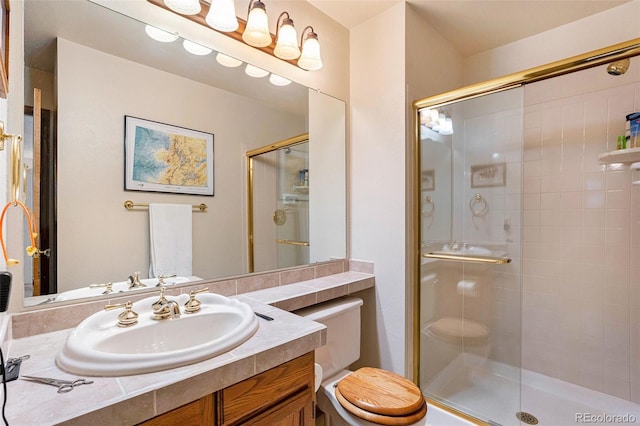 bathroom featuring a stall shower, vanity, and toilet