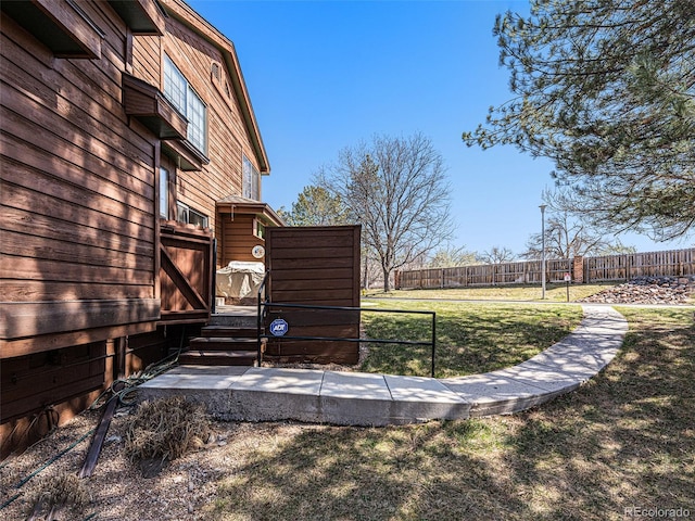 view of yard featuring a wooden deck and fence
