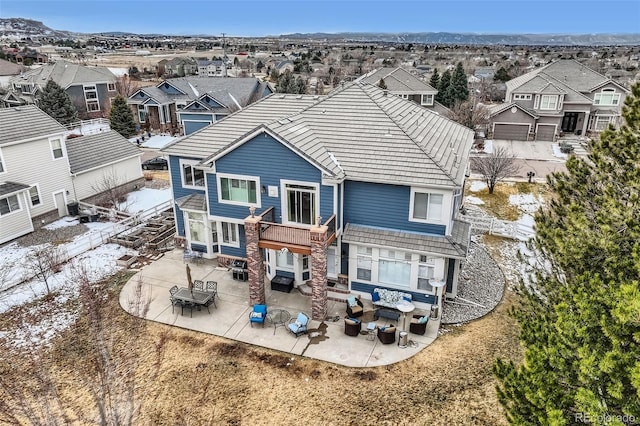 back of property featuring a patio and an outdoor hangout area