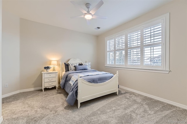 bedroom featuring light colored carpet and ceiling fan