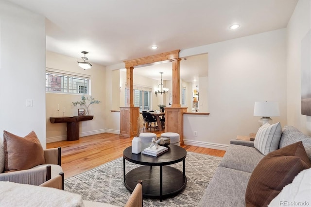 living room with wood-type flooring and a notable chandelier