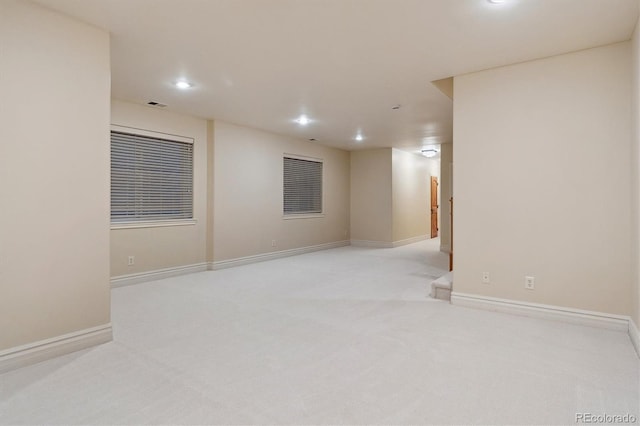 basement featuring light carpet