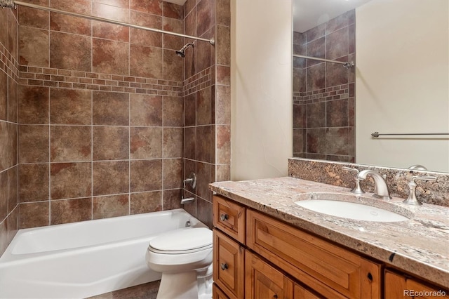 full bathroom featuring toilet, vanity, and tiled shower / bath combo