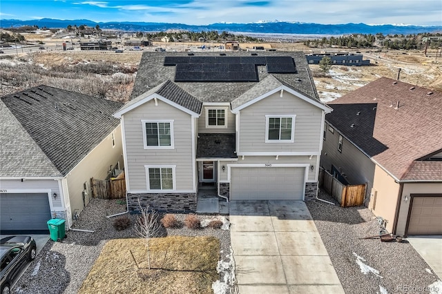 view of property featuring a mountain view and a garage